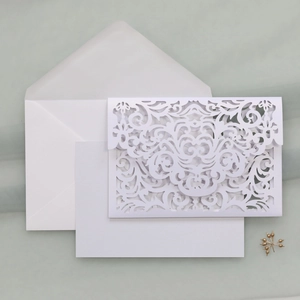 Detailed laser cut white wedding invitation set with floral cover and inner card