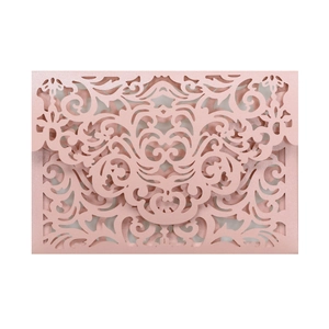 Detail showing laser-cut rose gold wedding invitation with intricate floral patterns