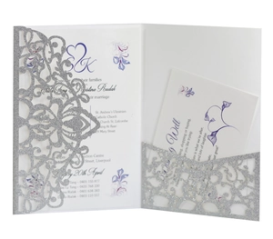 Detailed laser-cut silver glitter wedding invitation with elegant purple floral insert card