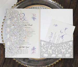 Macro shot of silver glitter laser cut wedding invitation with Wishing Well insert card