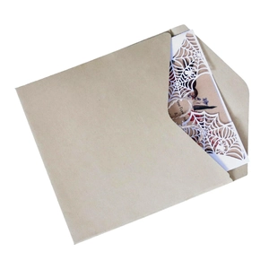 Detail of laser-cut spider web greeting card with vintage kraft paper envelope