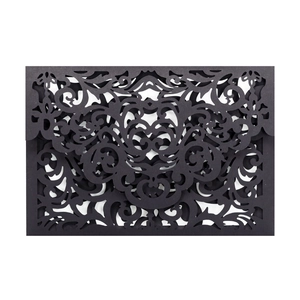Intricate laser-cut floral pattern on elegant black paper wedding invitation sleeve