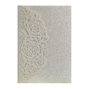 Detail of laser-cut rose hollow pattern on champagne gold glitter invitation card