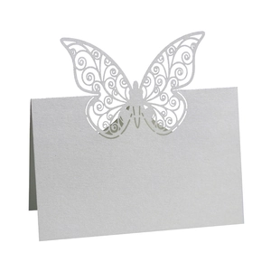 Detailed laser-cut butterfly place card with white pearlescent finish and intricate patterns
