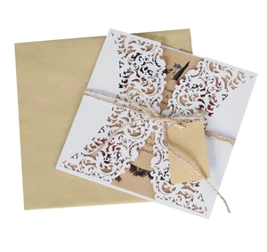 Elegant laser-cut floral wedding invitation set with kraft paper and rustic twine detail