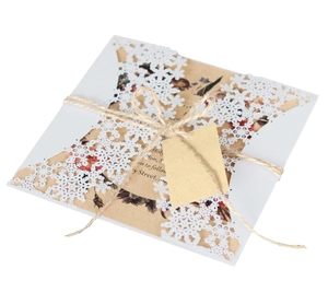 Detailed laser-cut snowflake envelope with rustic twine and kraft paper tag for holiday gift