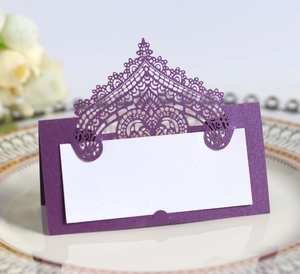 Detail of laser-cut lace wedding place card in purple with elegant white insert