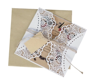 Detailed laser cut lace wedding invitation with kraft paper inserts and hemp twine decor