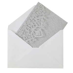 Detailed laser-cut silver glitter wedding invitation card with a minimal white envelope