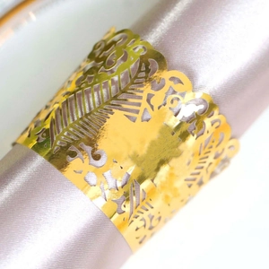 Elegant gold hollow-out laser cut napkin rings on lavender satin for wedding decor