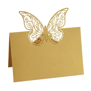 Elegant gold laser-cut butterfly place cards with pearlescent finish for wedding table decor