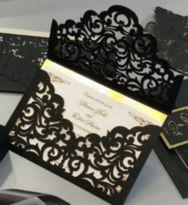 Detailed laser-cut black invitation envelope with elegant European镂空patterns and gold print