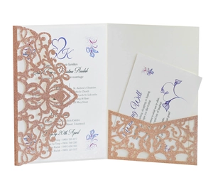 Detail of rose gold glitter laser-cut lace wedding invitation with floral vine patterns