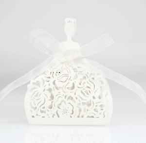 Detailed laser-cut floral pattern on white bridal dress shaped favor gift box with ribbon