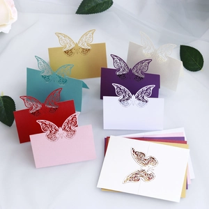 Laser cut butterfly place cards for weddings featuring intricate wing patterns and vibrant colors