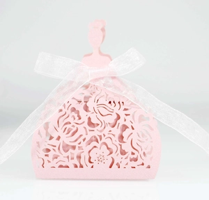 Pink laser-cut paper gift box in elegant dress shape with a white organza ribbon