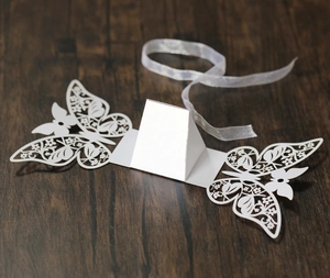 Detailed laser-cut hollow butterfly design on high-quality white paper candy box