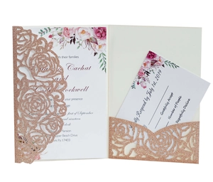 Macro detail of laser-cut rose gold glitter wedding invitation with floral insert