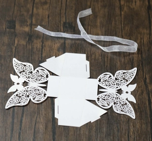 Detailed laser-cut butterfly hollow pattern on white paper wedding favor box