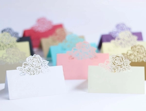Detailed laser-cut rose hollow place cards in multiple colors for wedding table settings