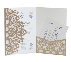 Macro view of laser-cut glitter gold invitation with purple floral printed inner card