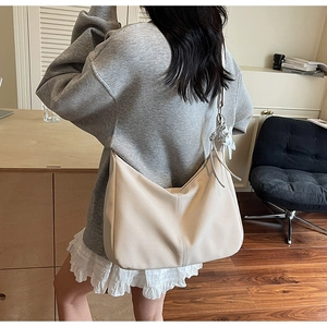 Close-up of beige Hobo tote bag showing textured material and drawstring detail