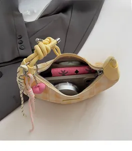 Top view of yellow checkered crescent bag showing spacious interior with daily essentials