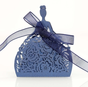 Detail of laser-cut floral pattern on dark blue wedding favor box with ribbon