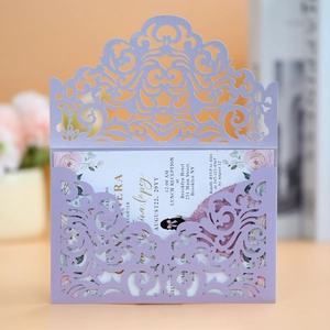 Detail of laser-cut lavender wedding invitation with floral printed insert card