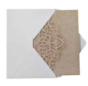 Detailed laser-cut gold glitter wedding invitation with intricate mandala floral patterns