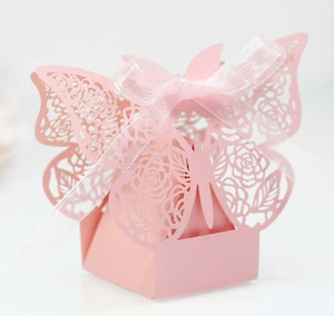 Detail of pink laser-cut gift box with intricate butterfly lid and silk ribbon