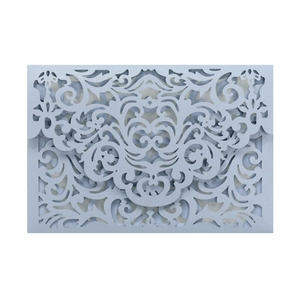 Macro detail of laser-cut damascus patterns on silver pearlescent wedding invitation cover