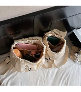Top-down interior view of beige canvas backpack showing large capacity and internal pockets