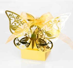 Detailed view of laser-cut butterfly wedding favor box in reflective gold paper