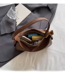 Top view of brown lychee leather crescent bag showing spacious interior with essentials