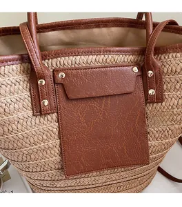Detail of woven straw texture paired with brown lychee leather trim and silver studs