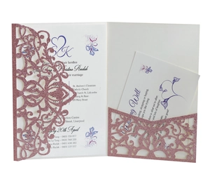 Detail of rose gold glitter laser-cut wedding invitation with elegant floral mandala pattern