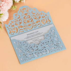 Detailed laser-cut pattern on light blue wedding invitation sleeve with inner card