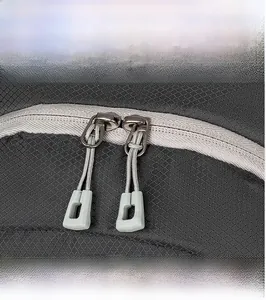 Close-up of smooth two-way metal zippers and durable ripstop nylon on a hiking backpack