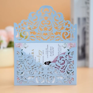 Intricate laser-cut floral wedding invitation set in light blue with elegant insert card