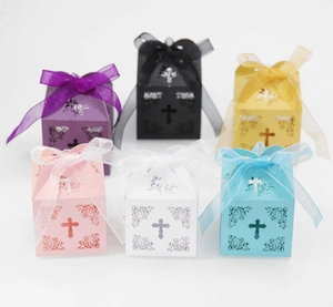 Laser-cut hollow cross favor boxes in multiple colors with organza ribbon decoration