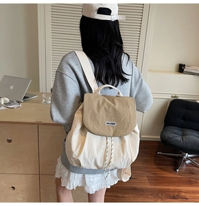 Detailed view of the drawstring closure and stitching on the canvas backpack