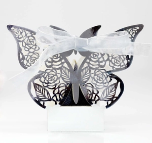 Detail of laser-cut butterfly gift box in black cardstock with white silk ribbon bow