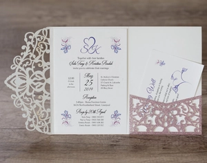 Detail of pink glitter laser cut wedding invitation with purple floral insert cards