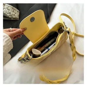 Detailed top view of the yellow checkered bag showing internal capacity and braided strap