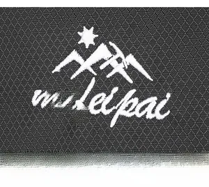 Macro view of durable ripstop nylon fabric with white mufelpai mountain logo embroidery