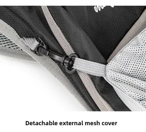 Detail of outdoor backpack showing detachable plastic buckle for mesh cover attachment