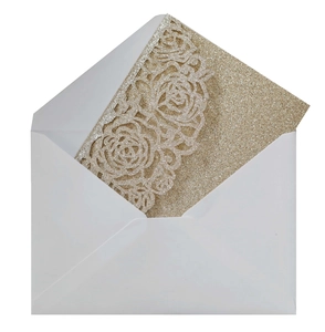 Detail of glitter gold laser-cut rose invitation card in white envelope for weddings