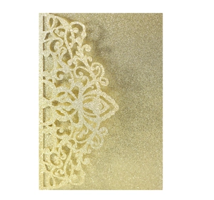 Intricate laser-cut floral lace detail on gold glitter wedding invitation card