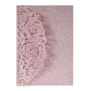 Detail of pink glitter laser cut wedding invitation cover with intricate rose floral pattern